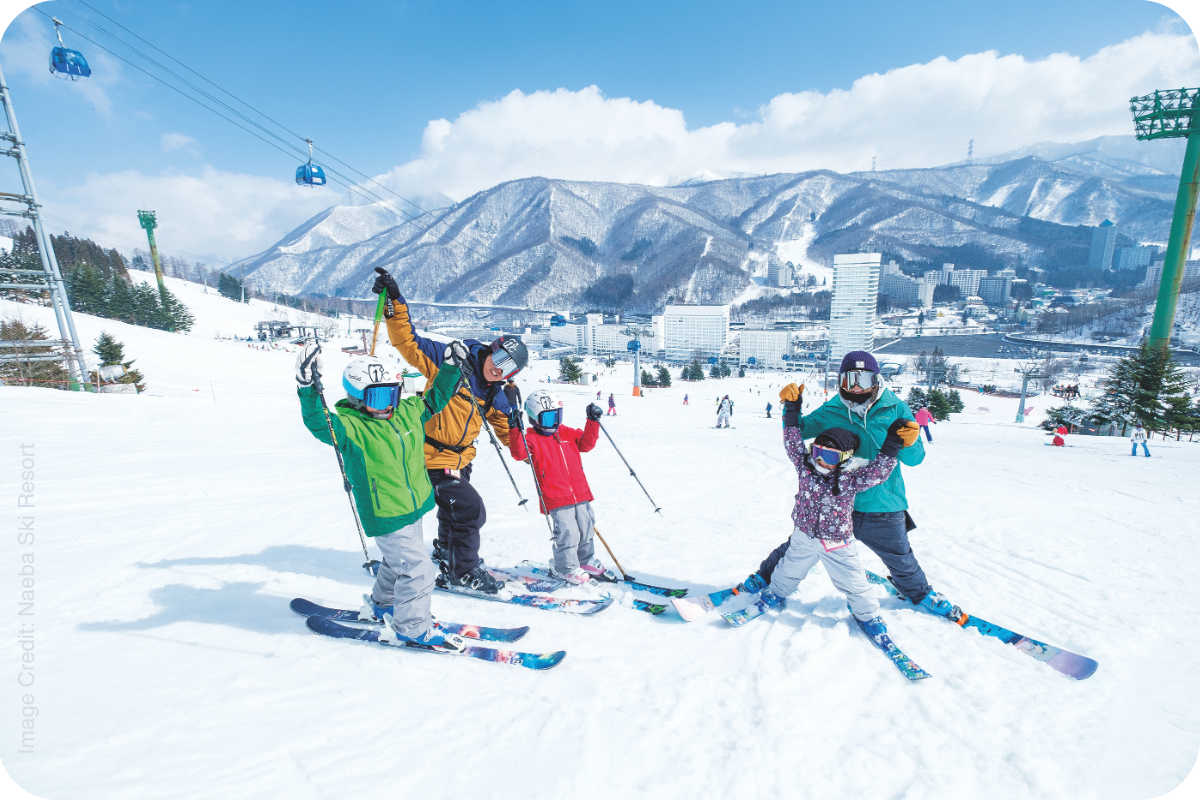 Family of skiers celebrating on the slopes