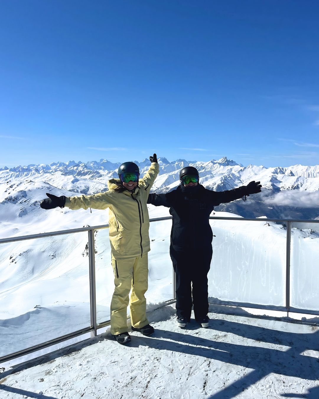 MySnow ski specialists Emily A and Emily P on a sunny viewing platform in Les 3 Vall&eacute;es