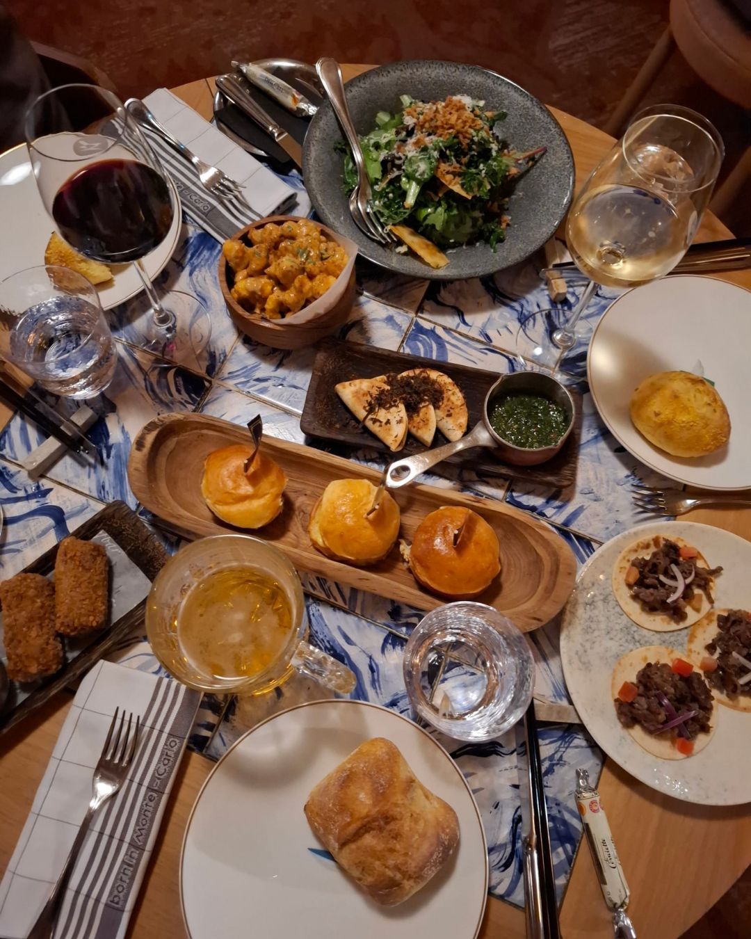 Sharing plates and wine at dinner in M&eacute;ribel