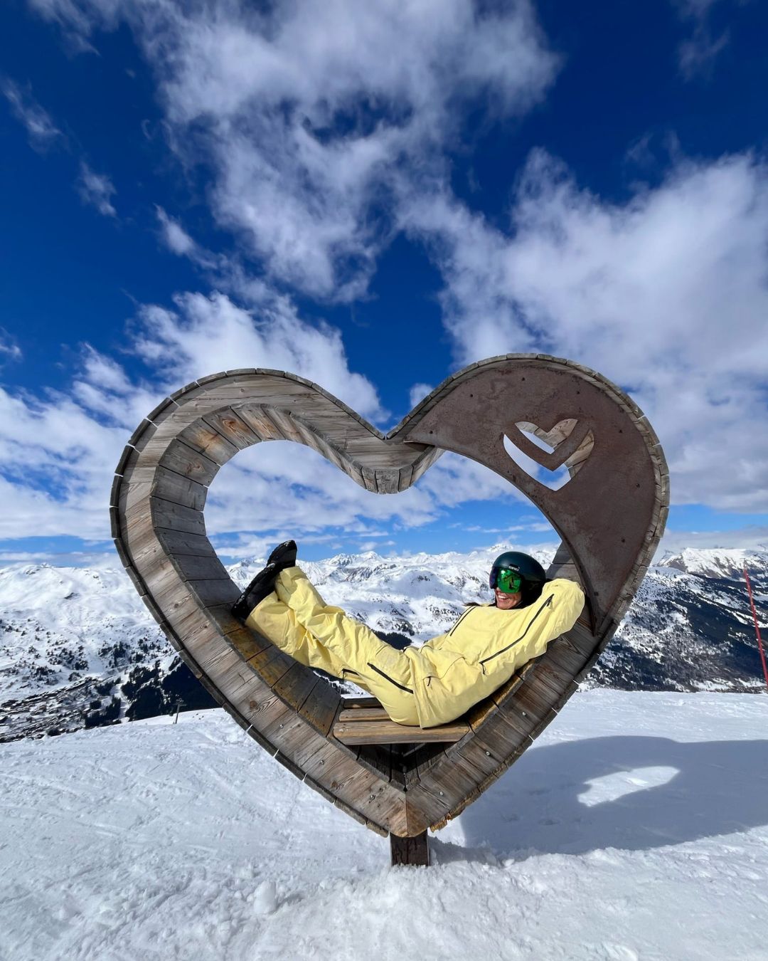 MySnow ski specialist Emily P relaxing in the heart-shaped seat above M&eacute;ribel