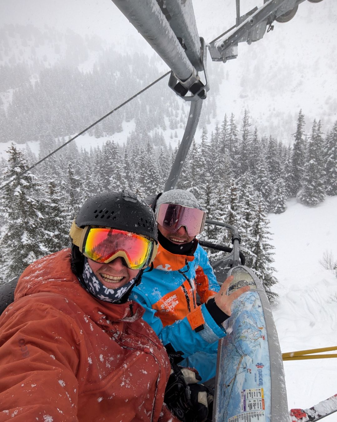 MySnow ski specialist George on a chairlift with a mountain guide in fresh snow