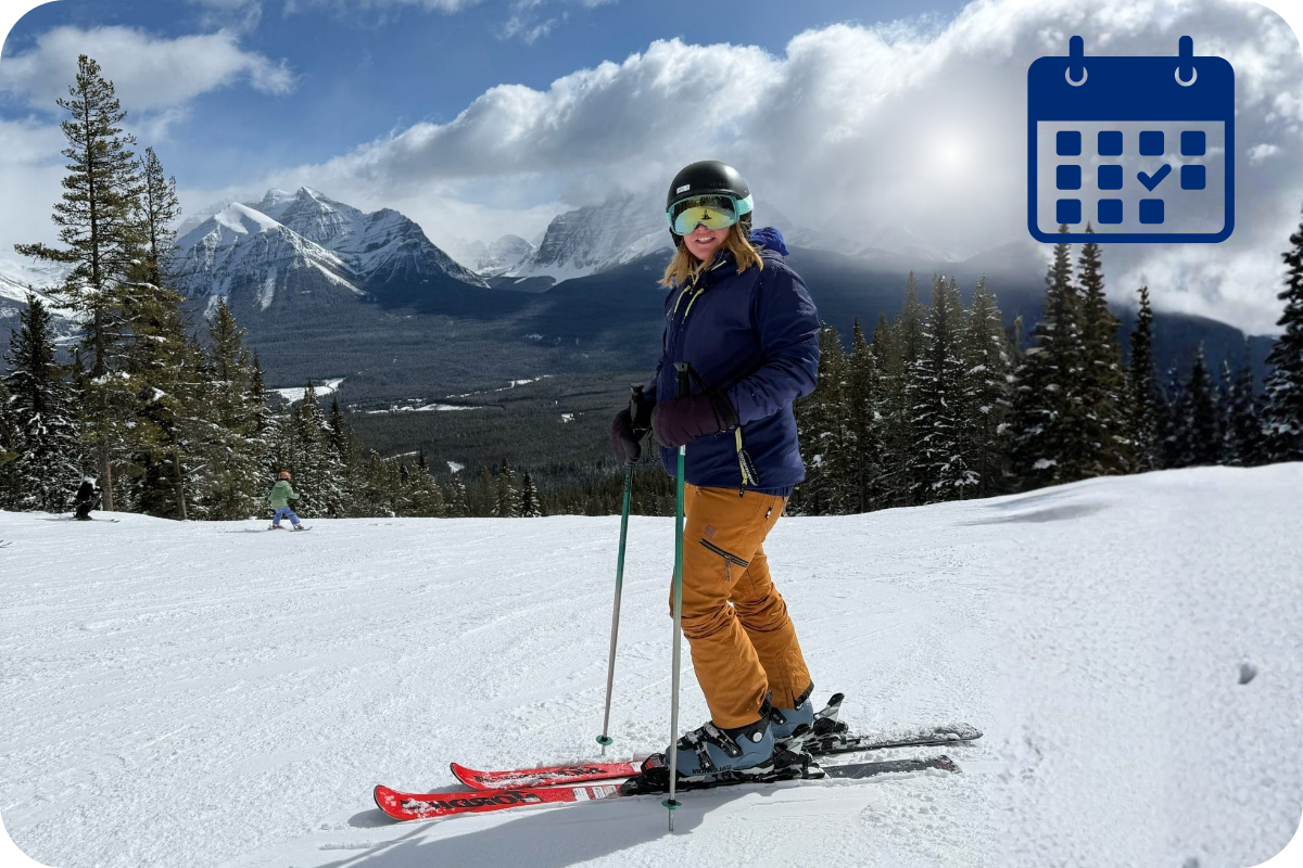 Skier standing on a sunny groomed run in Canada