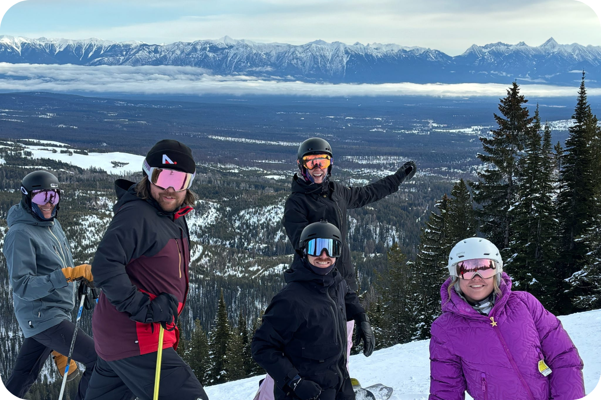 Our team on a mountain summit with valley views at Fernie