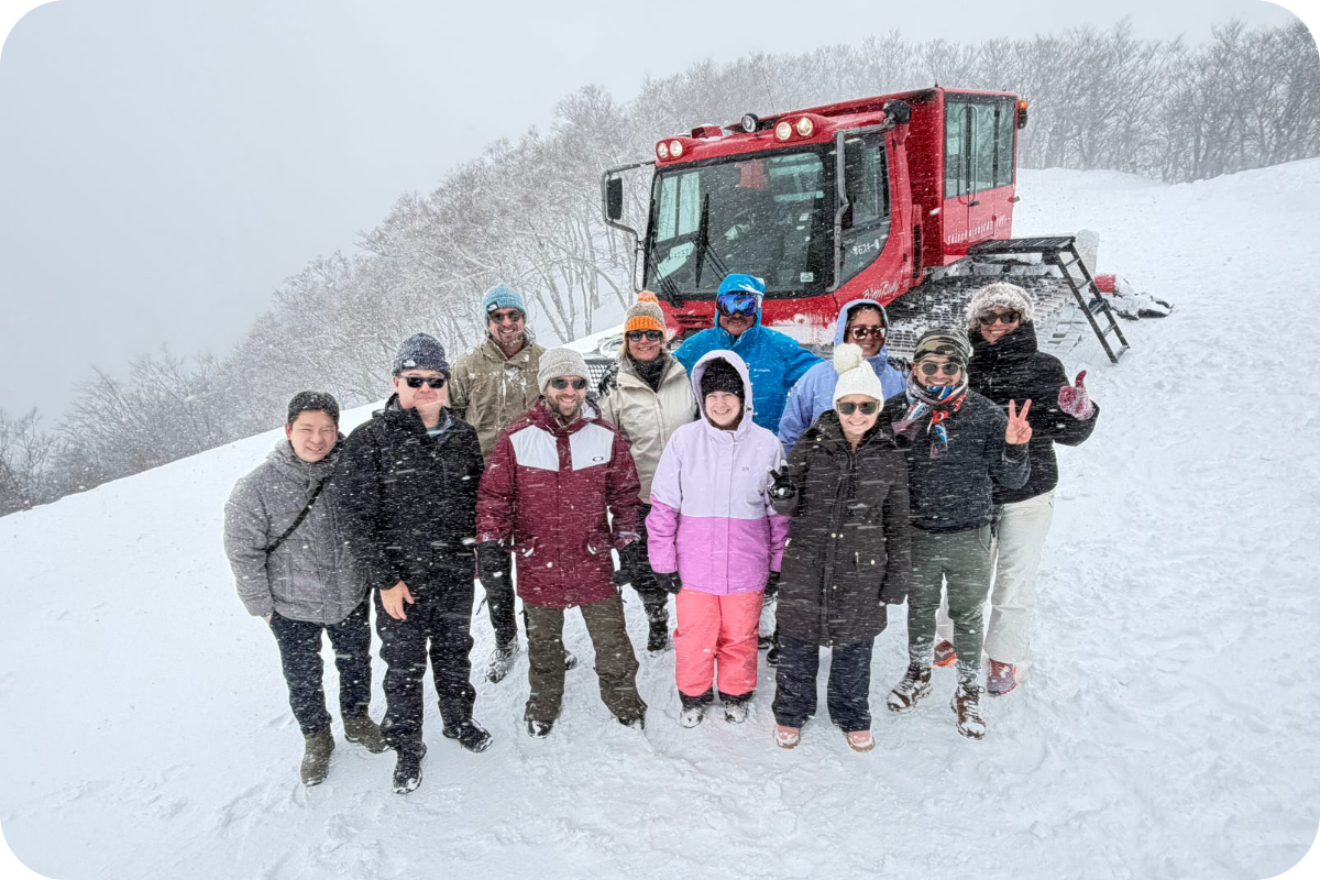 Our team with a snowcat in deep snow in Japan