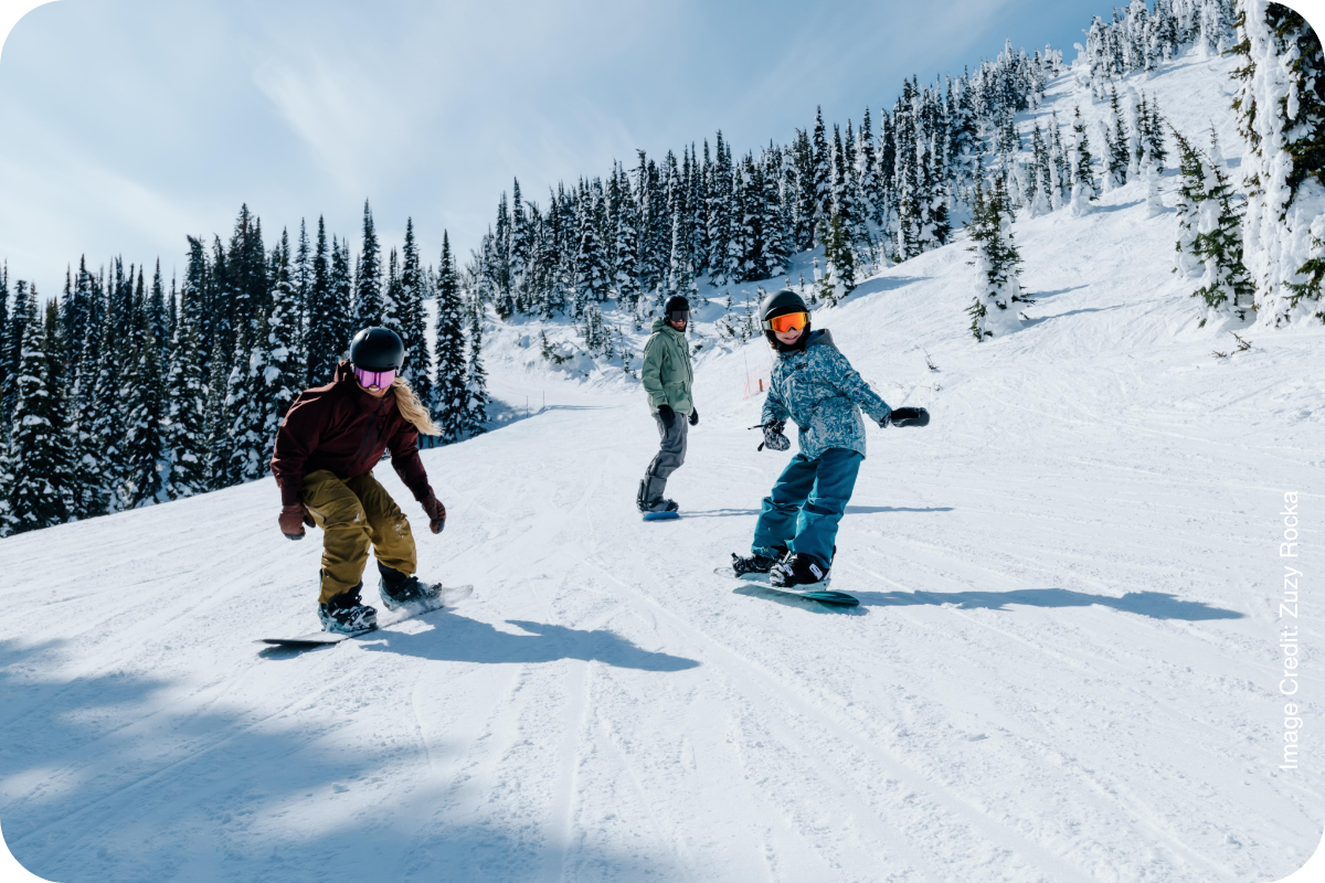 Skiers on a groomed run in British Columbia